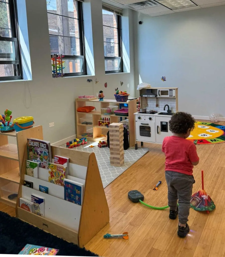 Caper ABA Therapy Center - therapy room with little kid walking around interacting with toys