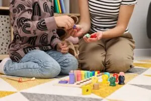 Therapist and child at aba therapy session after finding out the answer to the question, Does Insurance Cover ABA Therapy?.
