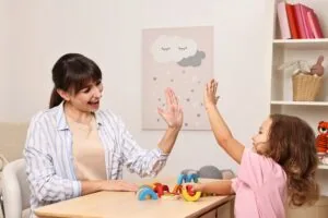Woman therapist teaching child aba therapy activities.