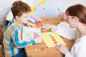 Boy talking to his therapist about what does aba therapy look like.